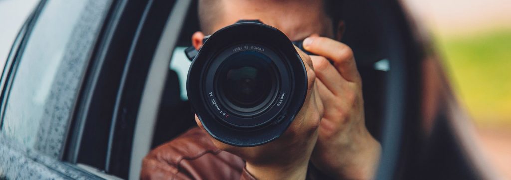 about-us infidelity investigator holding a camera