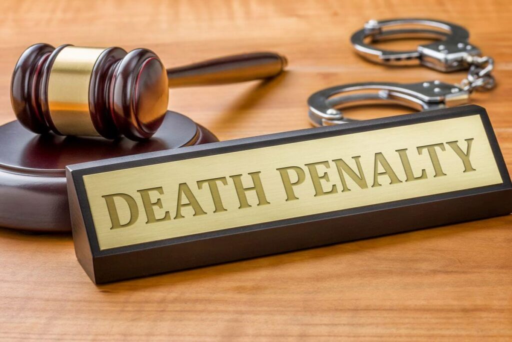 image showing a judge mallet, handcuffs and a nameplate saying death penalty